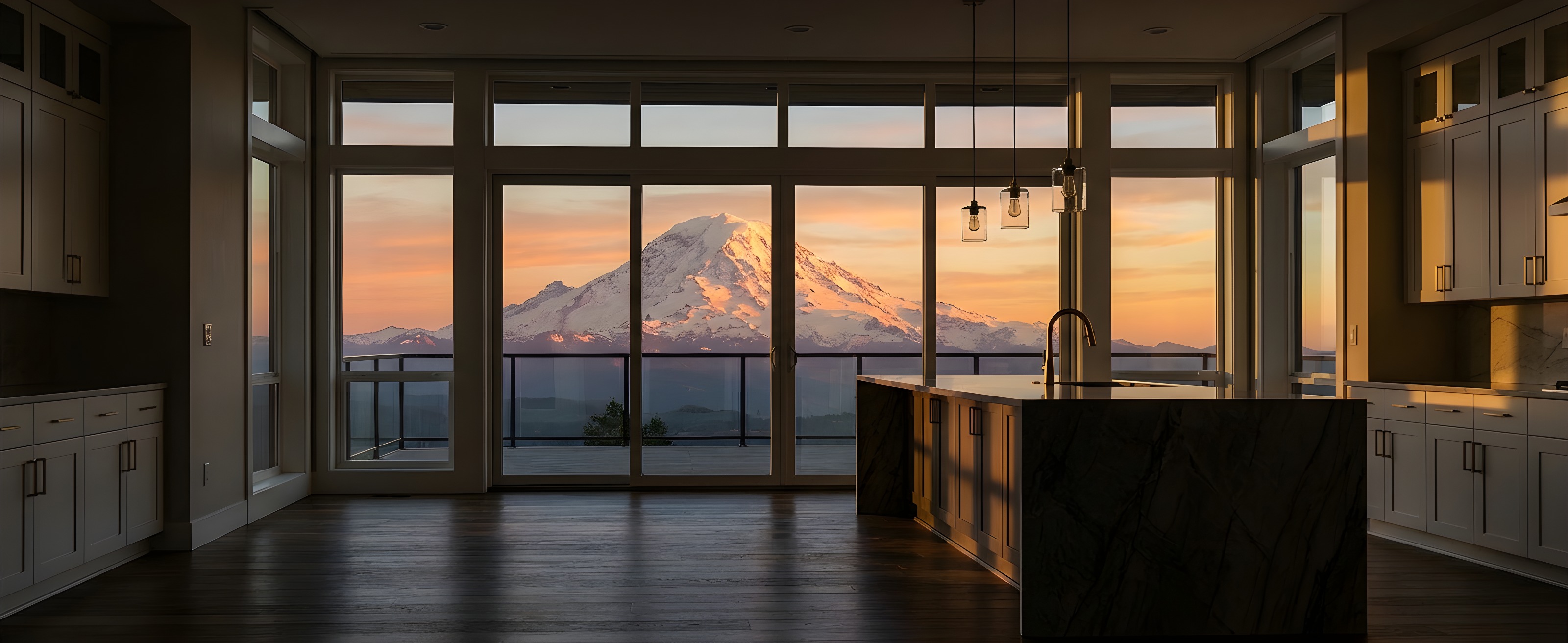 Luxury kitchen remodel with panoramic Mount Rainier sunset view through floor-to-ceiling windows